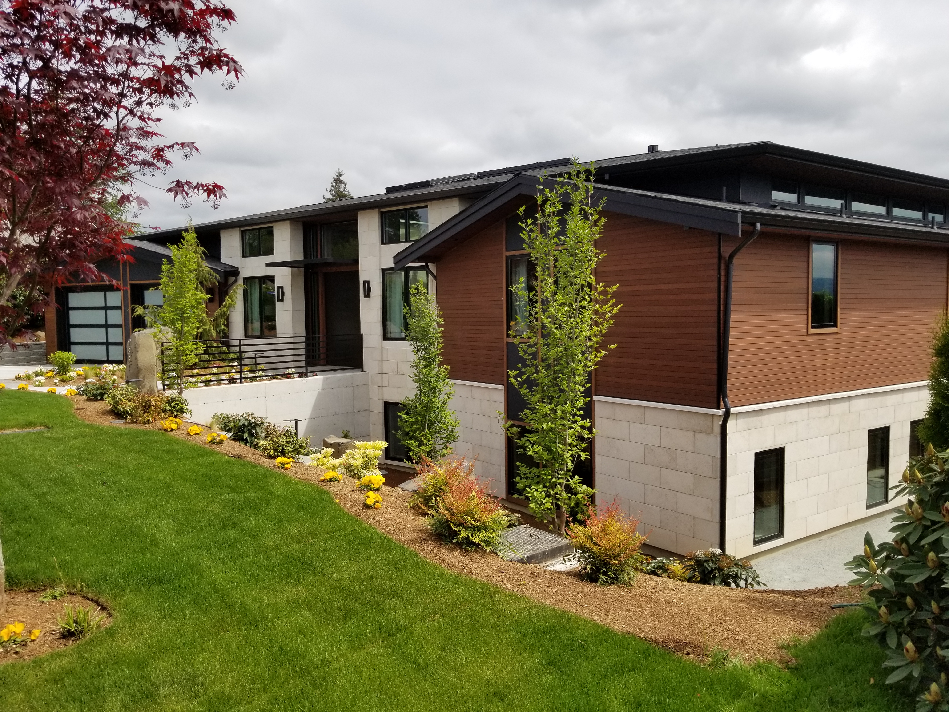 Modern home exterior with light stone veneer base walls